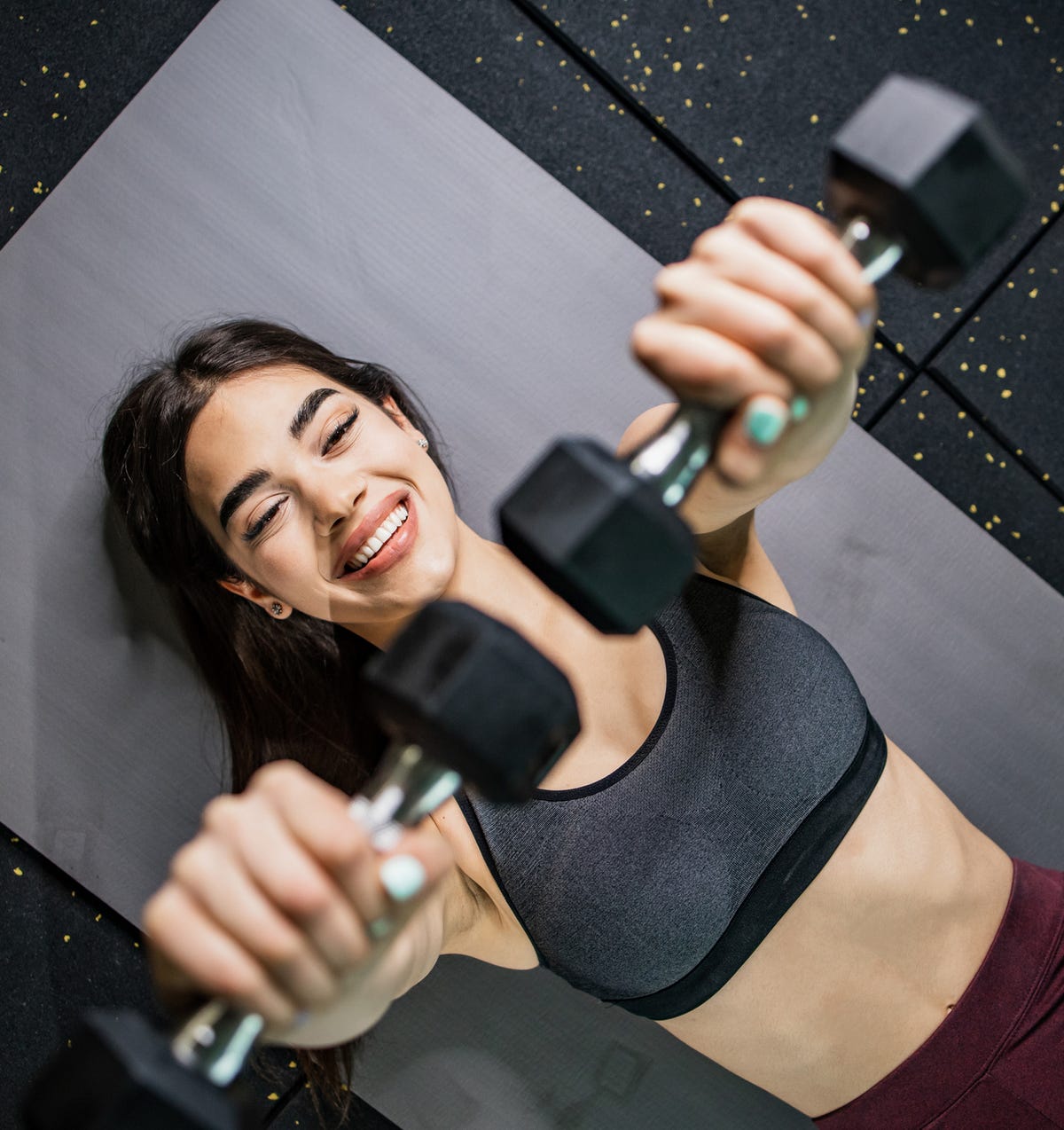 Woman performing dumbbell workout at the gym