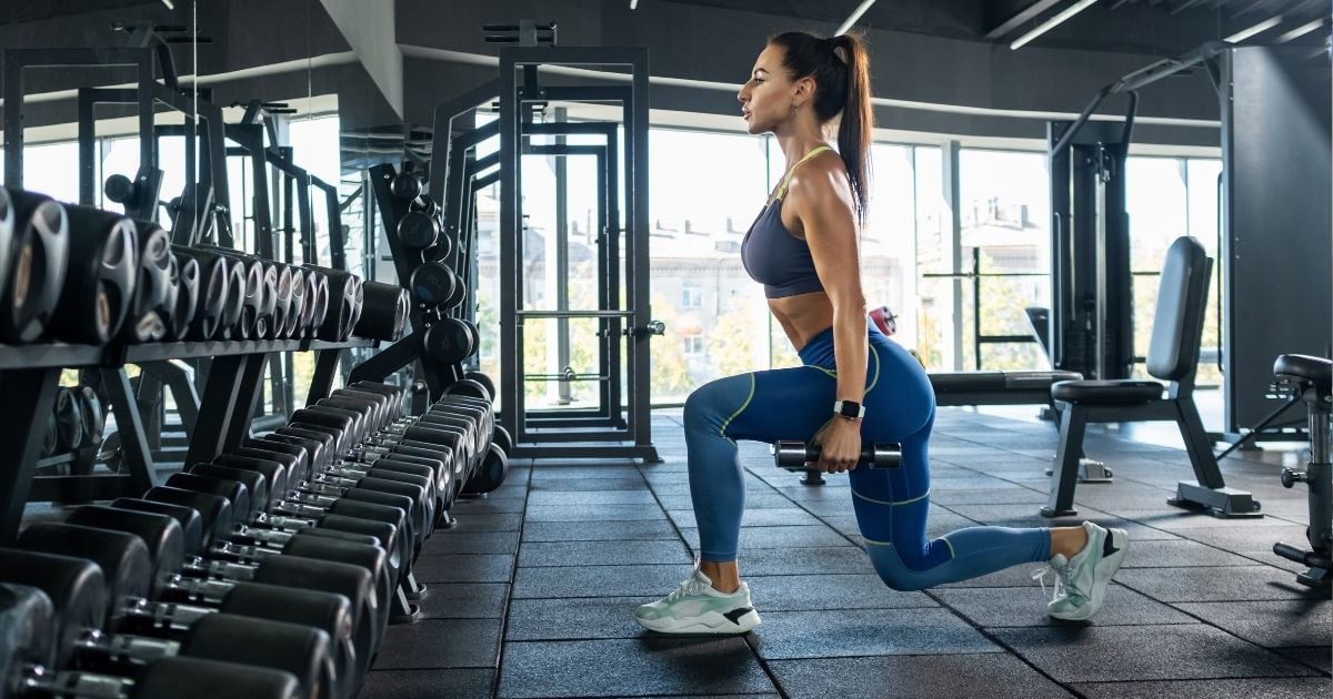 Woman performing squats in the gym